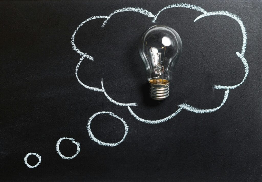 pexels photo 355952 355952 Light bulb laying on chalkboard with drawn thought bubble, symbolizing creative ideas.